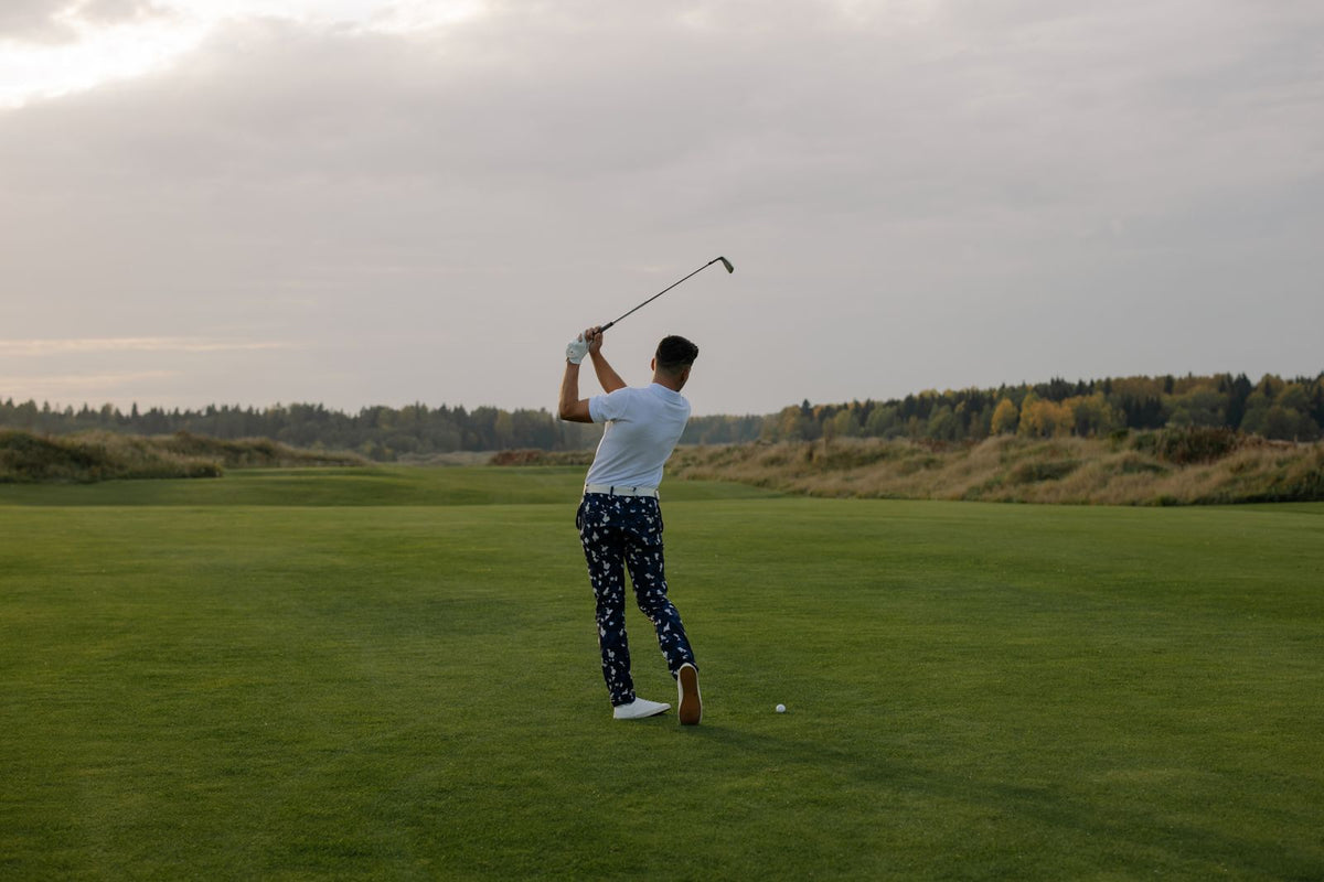 Golfer completing a full swing follow-through, demonstrating body connection